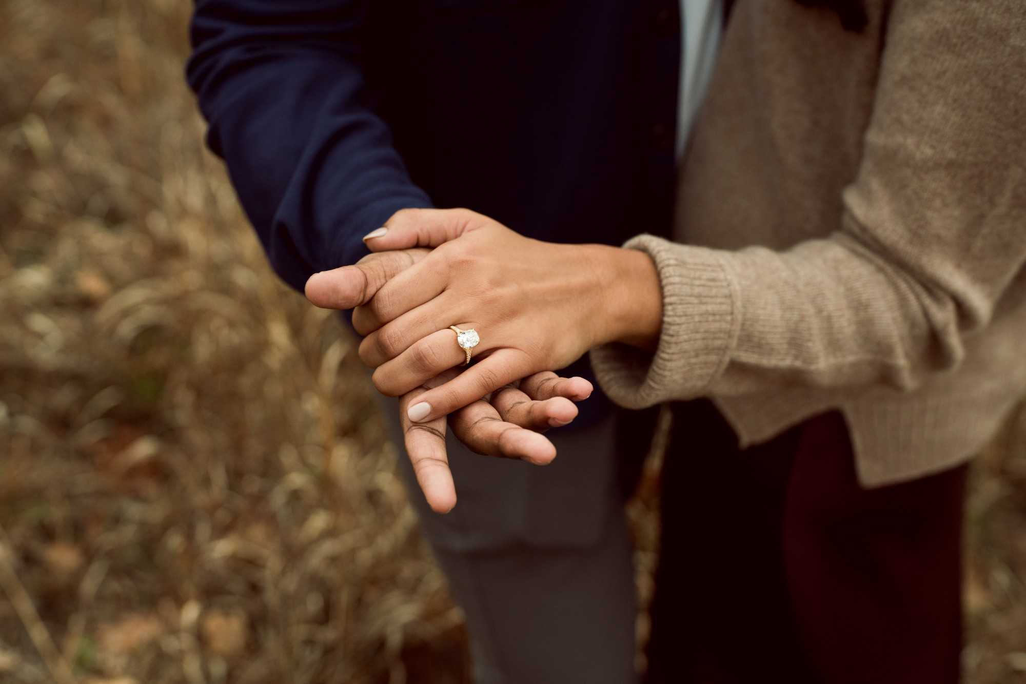 Myra and Rakesh holding hands, her engagement ring on show